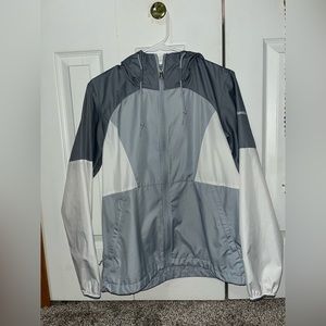 A grey and white Columbia rain coat size small